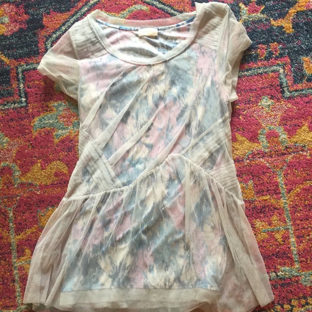 Peplum top with mesh overlay